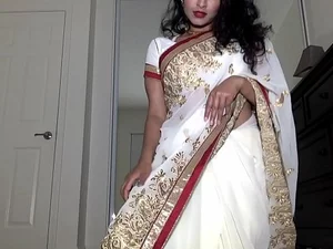 Desi night owl enjoys teasing with her saree, revealing her hairy pussy, and engaging in playful sex.