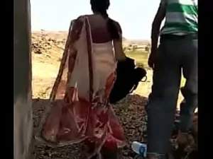 A mature Indian lady enjoys outdoor sex, including passionate anal penetration, with her young partner in a steamy encounter.